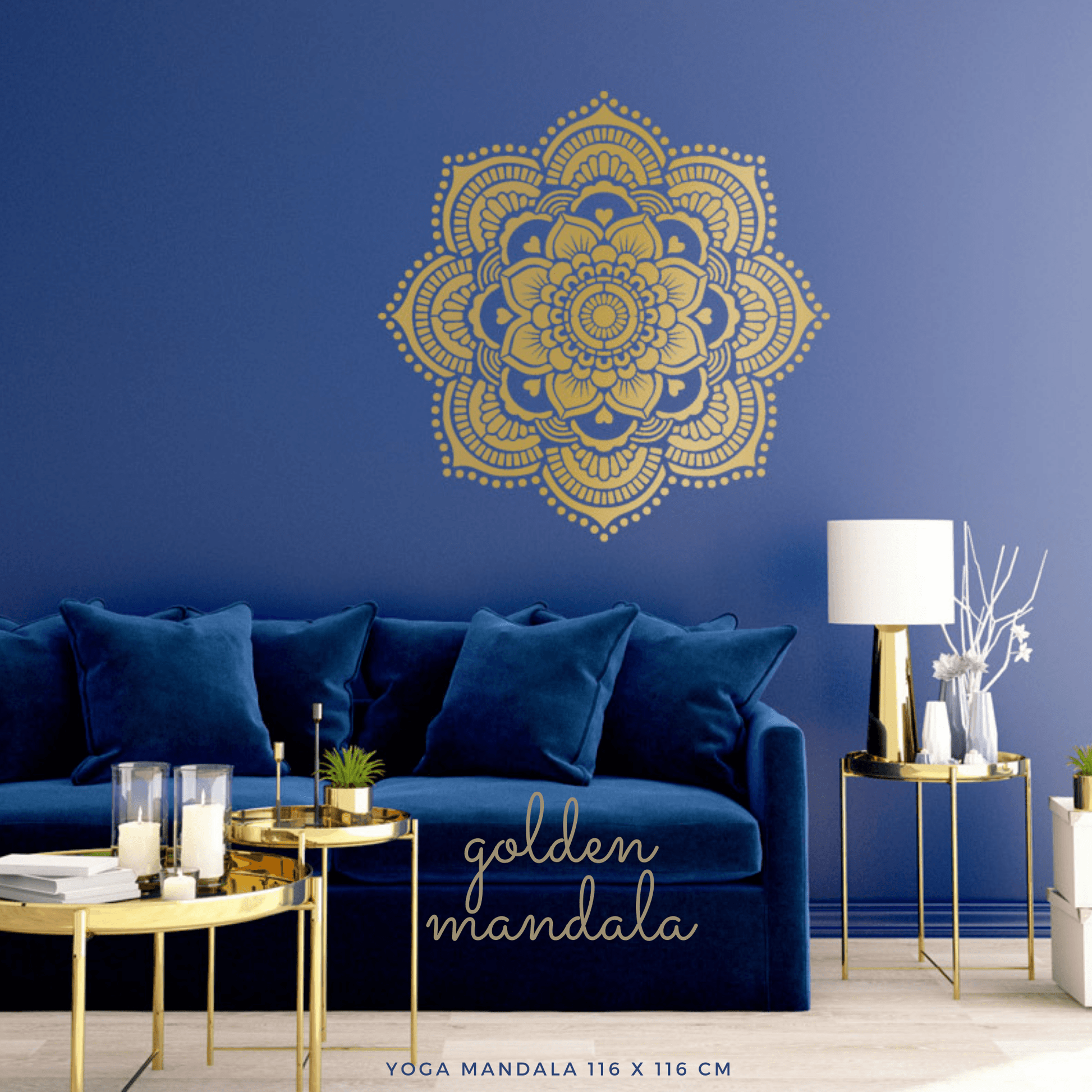 Large gold mandala wall stencil above deep blue velvet sofa with blue cushions.