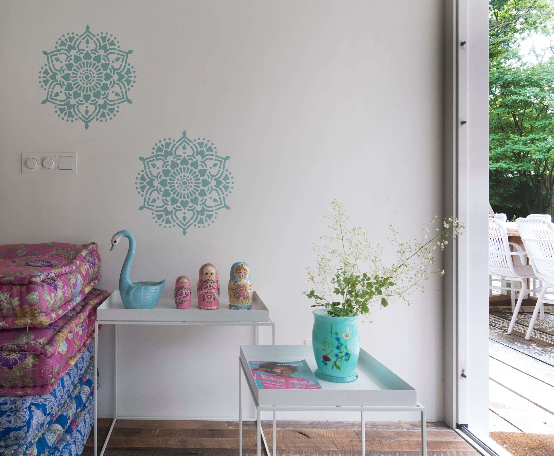 Blue Tibet mandala wall stencils in 45 cm size displayed on white wall in modern room setting.