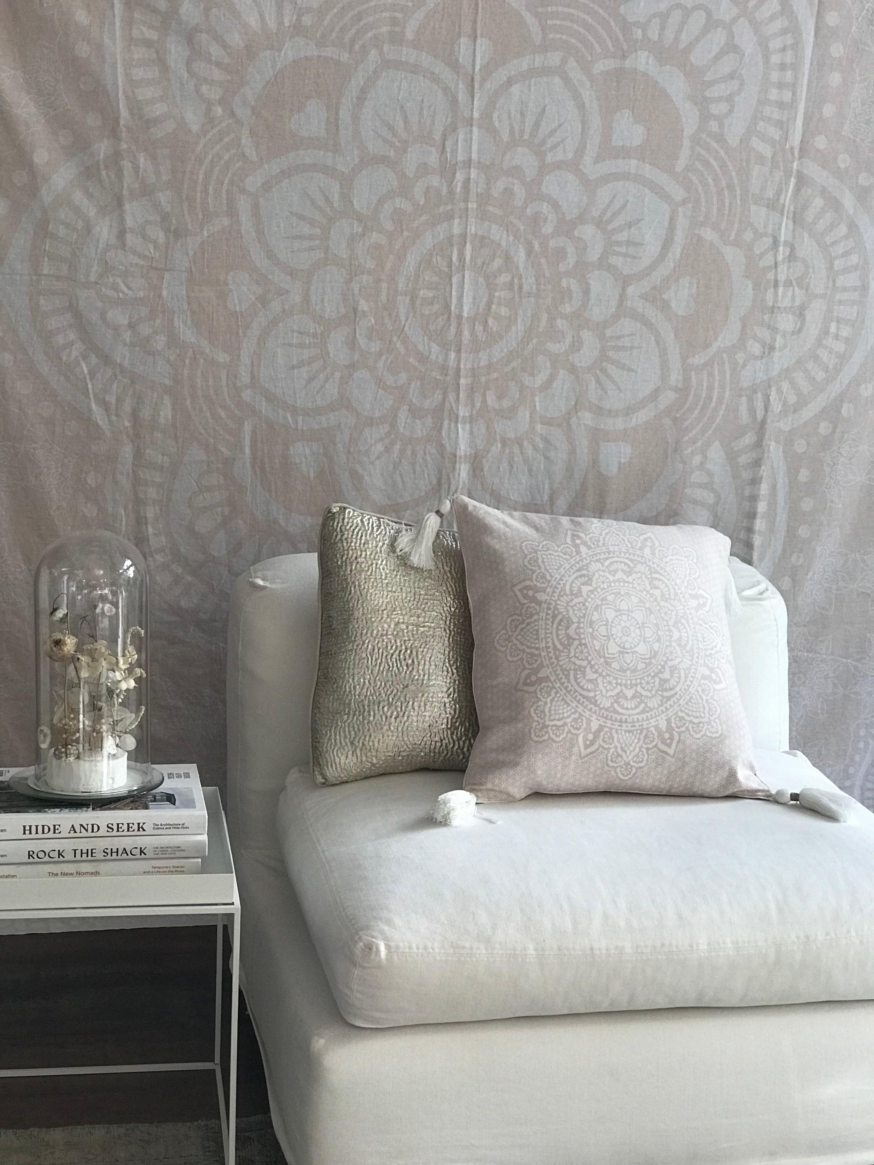 Square pink mandala cushion with intricate floral pattern on light fabric, 50x50 cm, on white chair.