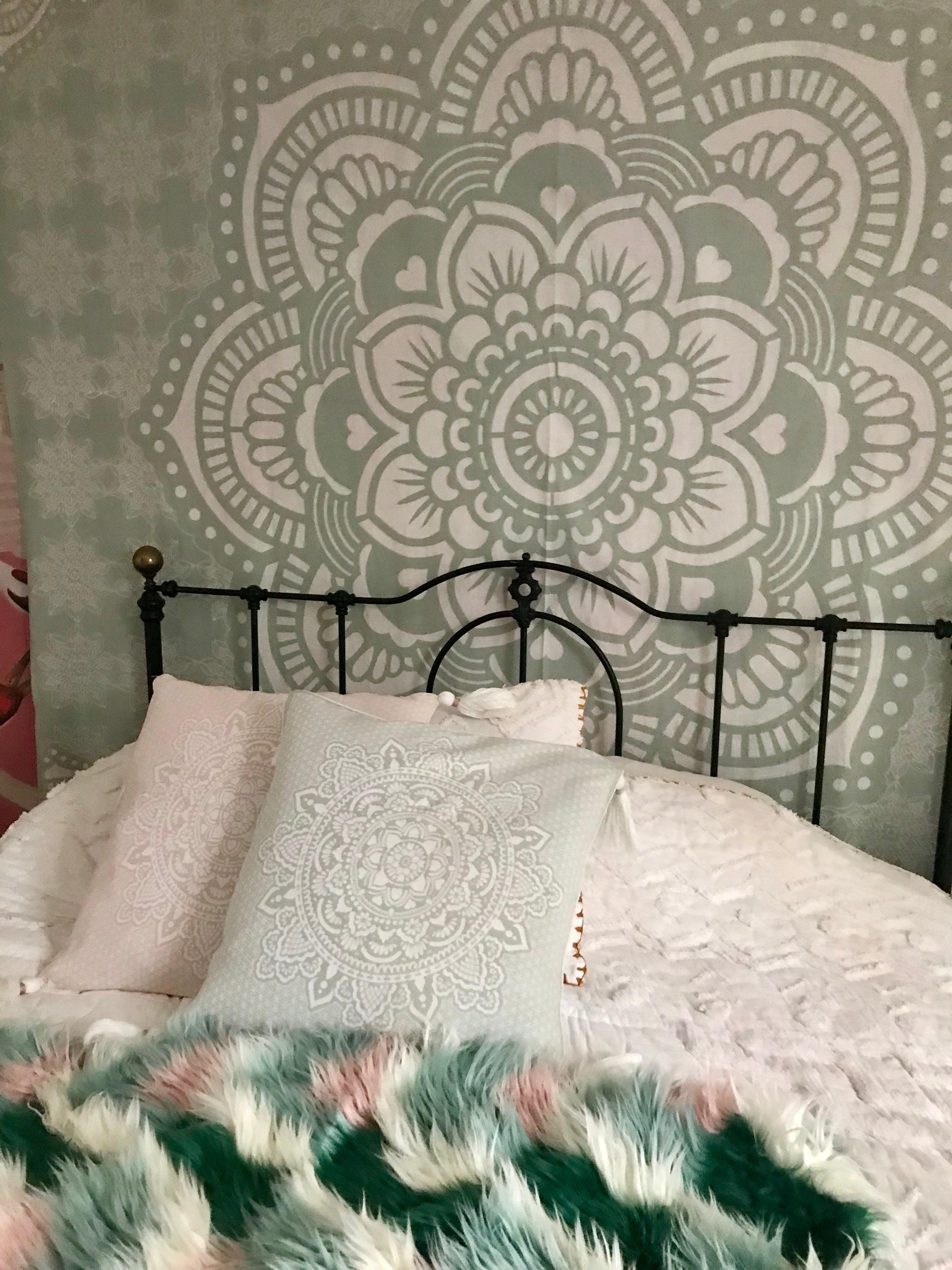 Mint green 50x50cm pillowcase with intricate white mandala pattern on bed with textured white bedding.