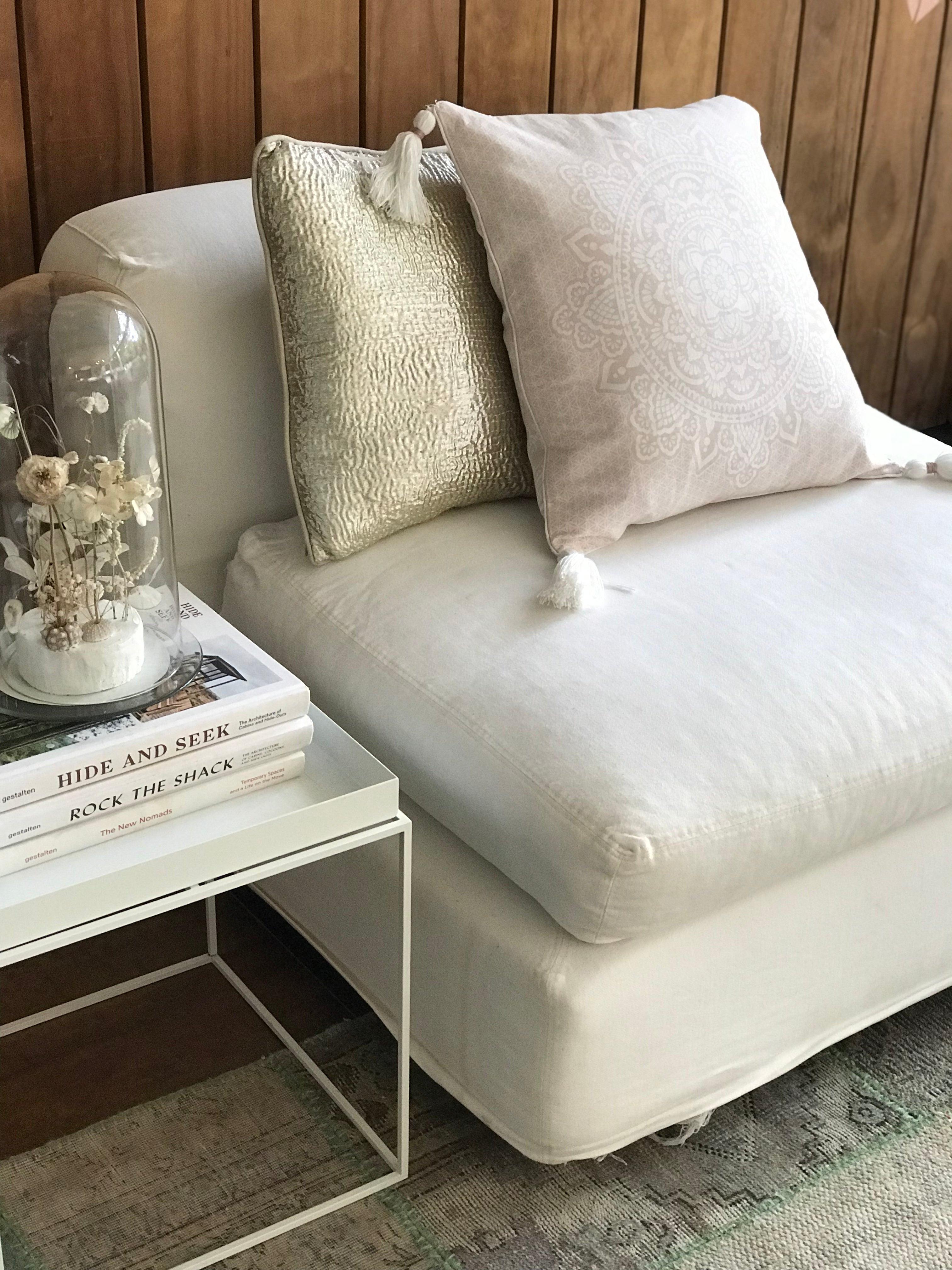 Soft pink mandala pillowcase 50x50 cm on white cushioned sofa with neutral pillow behind.