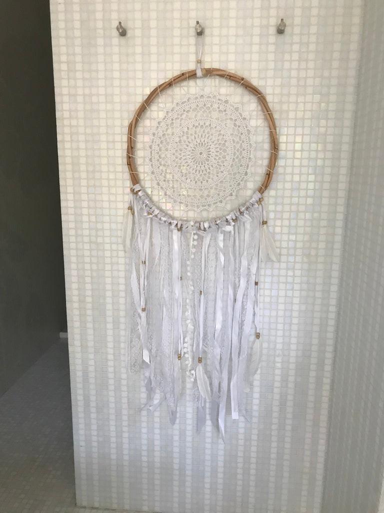 White crochet dream catcher with 42cm wooden hoop and hanging feathers and beads.